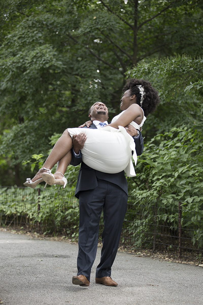 groom carrying bride
