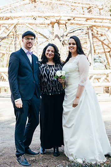bride and groom with officiant