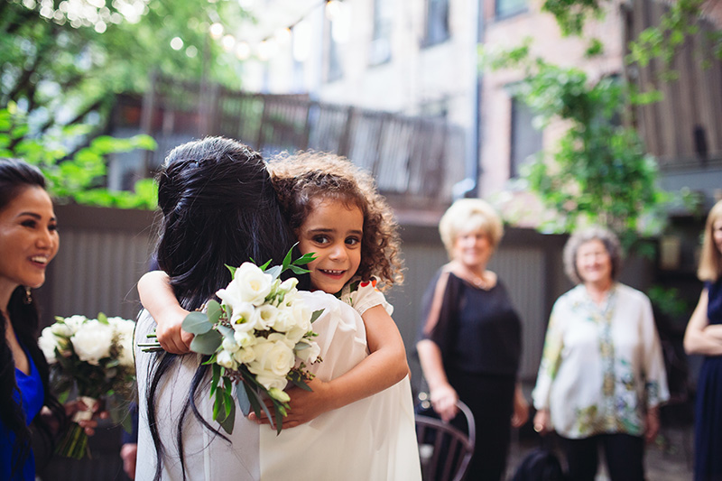 flower girl hugging bride