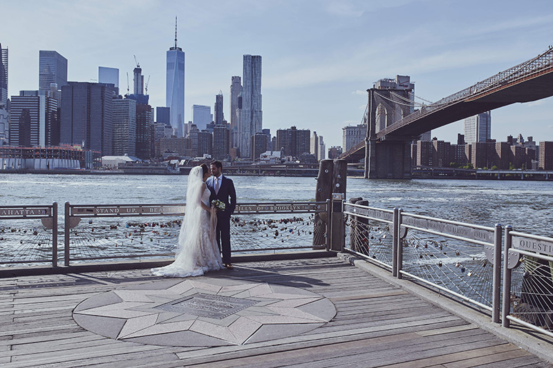 bride and groom under the Brooklyn bridge