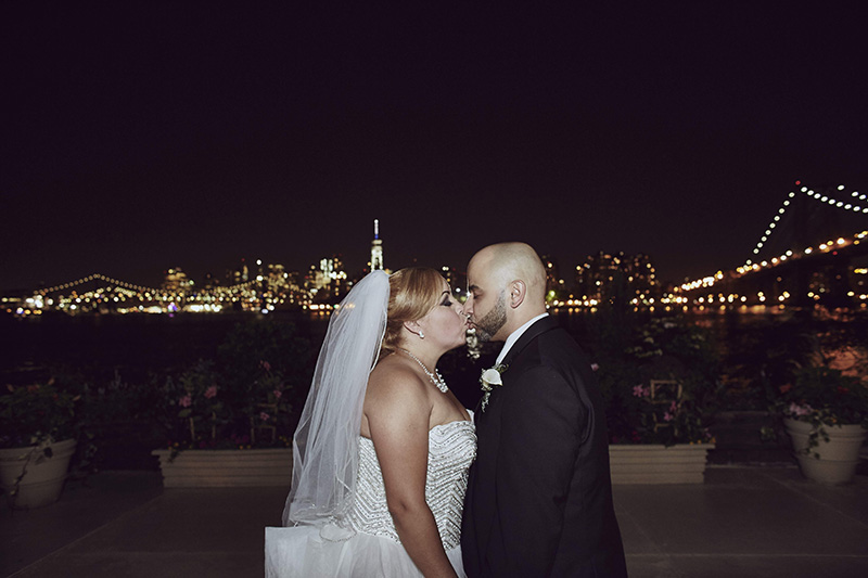 bride and groom kissing at night