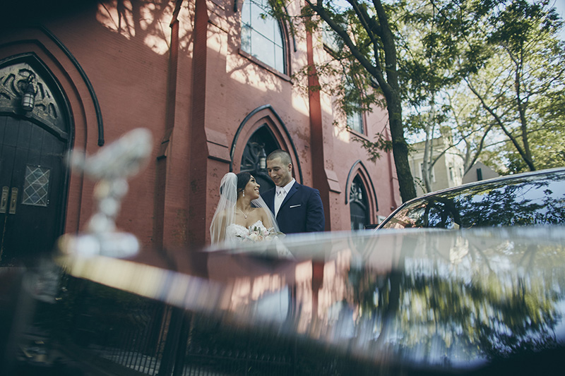 bride and groom in front of the church