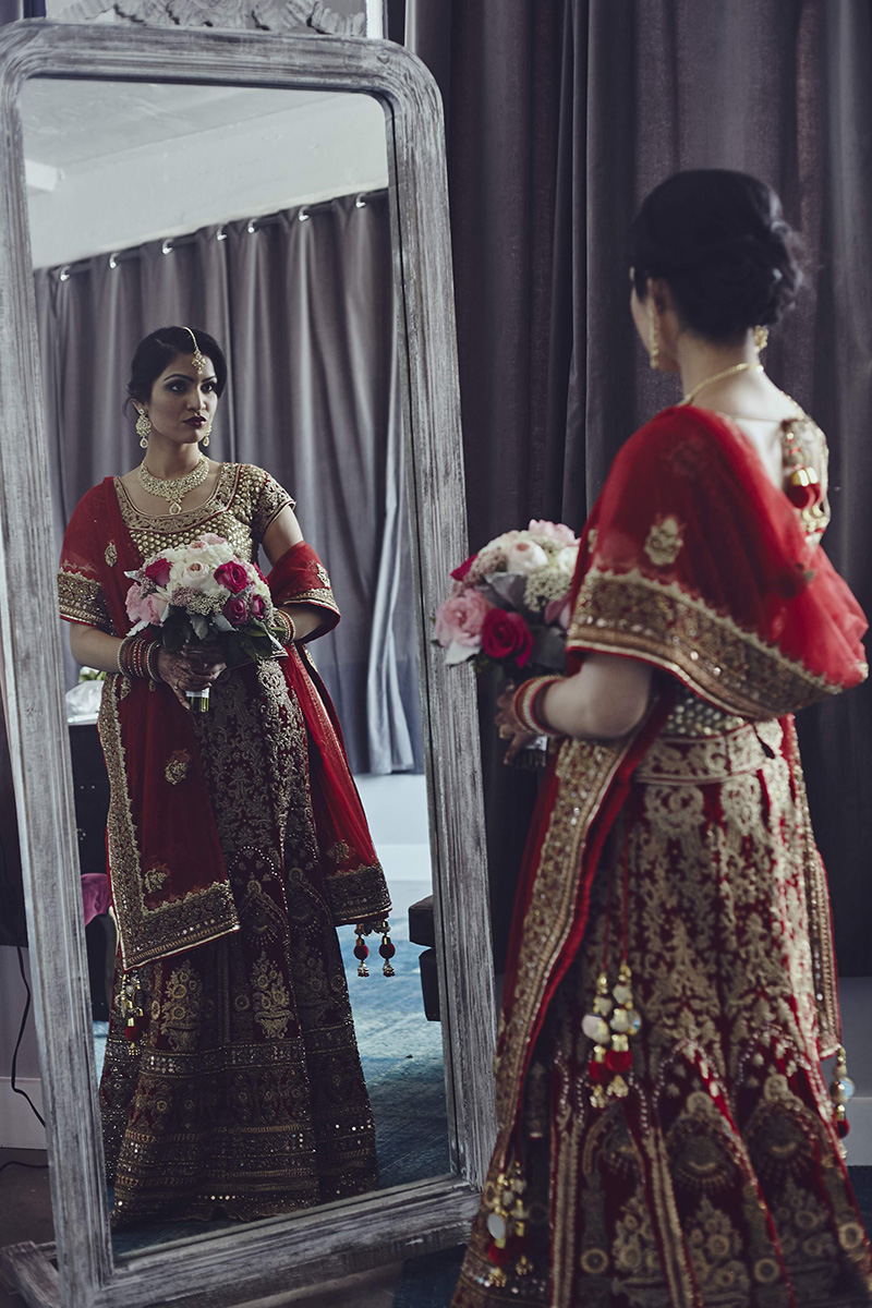 indian bride looking at the mirror