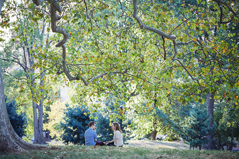 young couple sitting under the tree