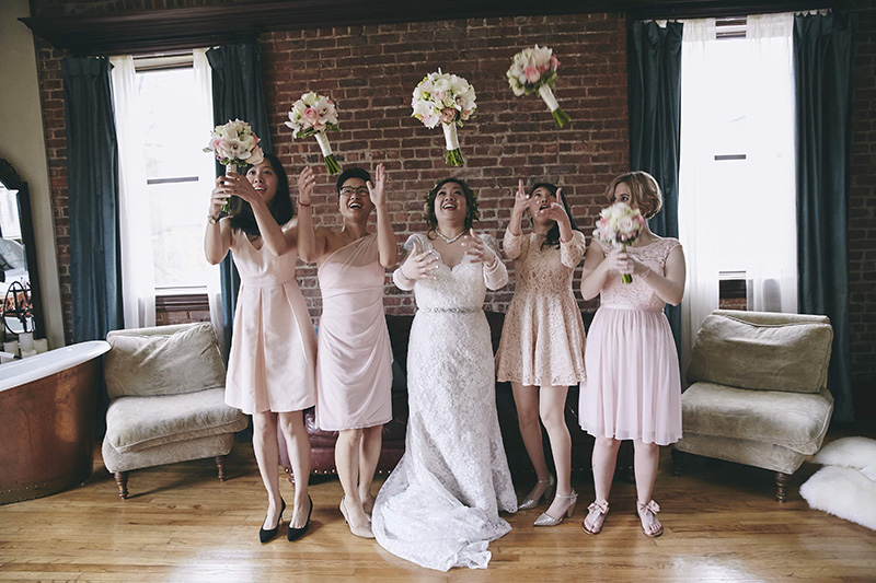 bridesmaids throwing wedding bouquets