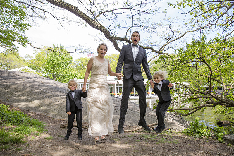 bride and groom with kids jumping