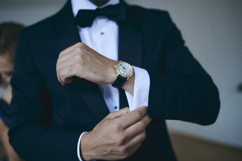 groom putting the watch on wrist