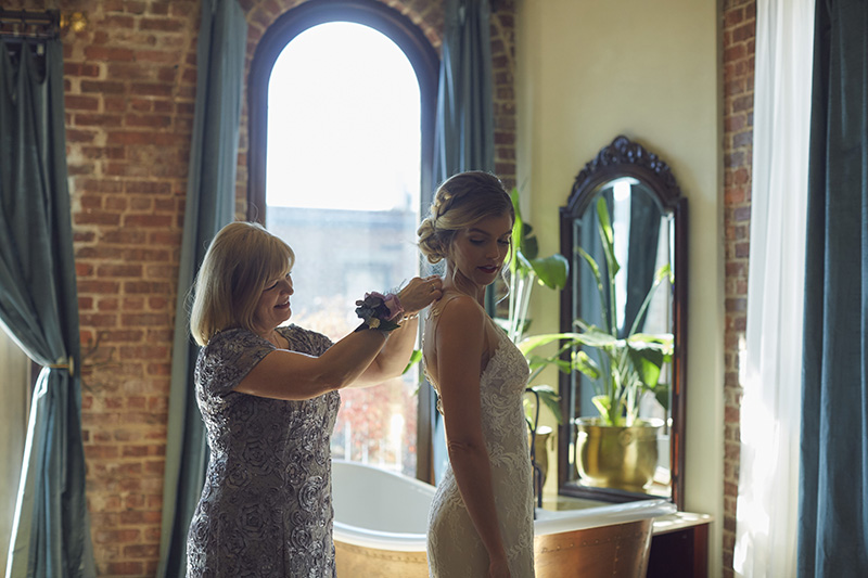 mother of the bride helping bride get ready