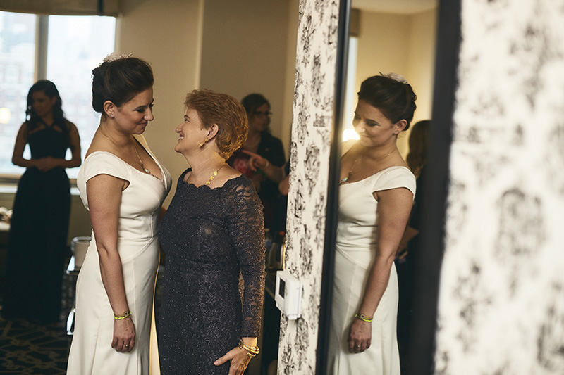 bride with her mother getting ready  for the wedding