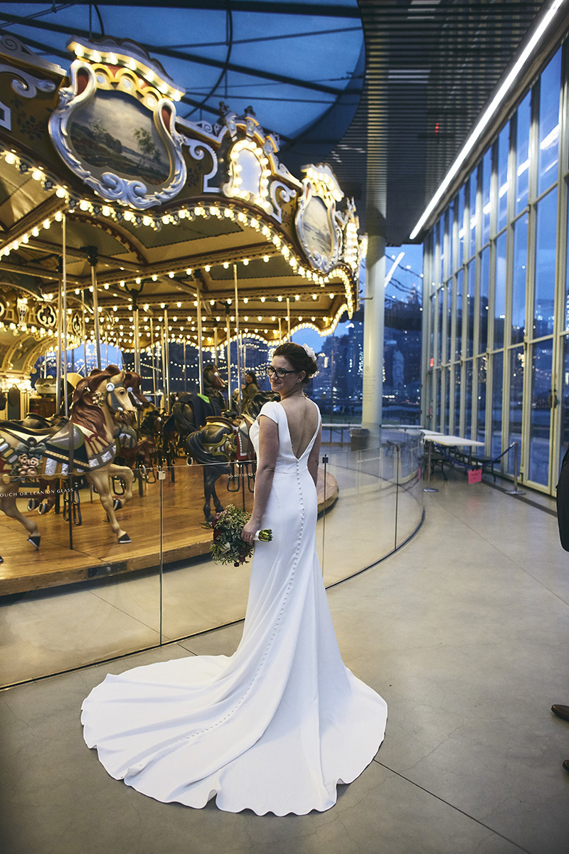 Bride posing by the carousel