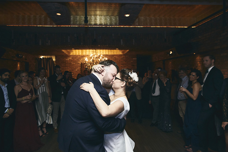Bride and groom kissing during their wedding dance