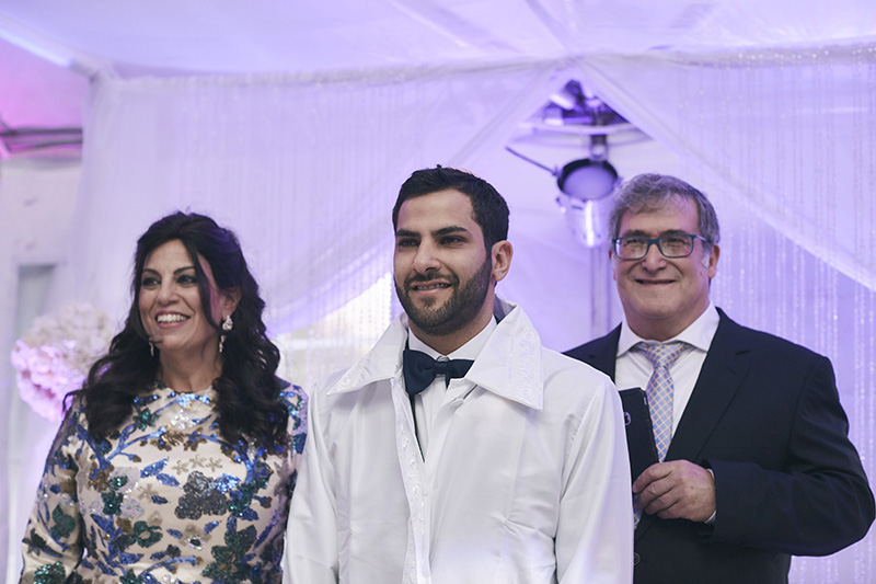 Orthodox Jewish groom with parents