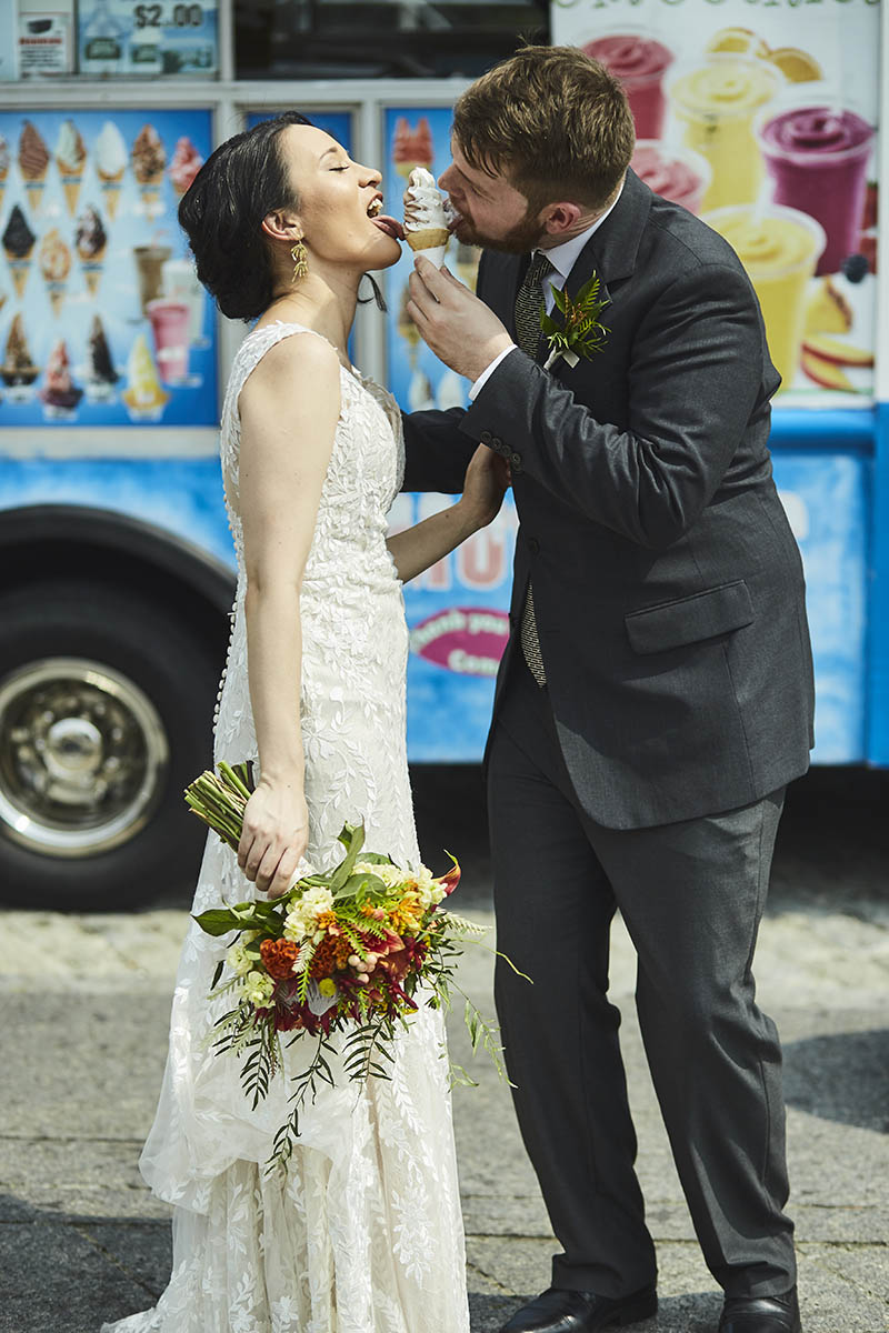 Bride and groom eating ice cream