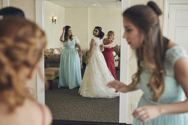 Bride putting the dress on