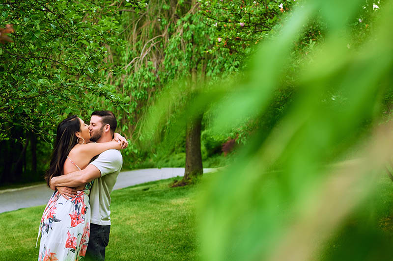 Couple hugging and kissing in front lawn