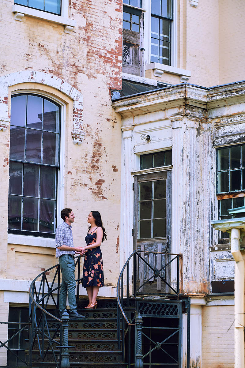 Couple standing on doorway of old building