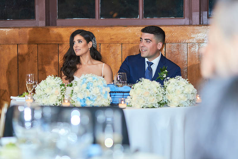 Bride and groom sitting at the sweetheart table