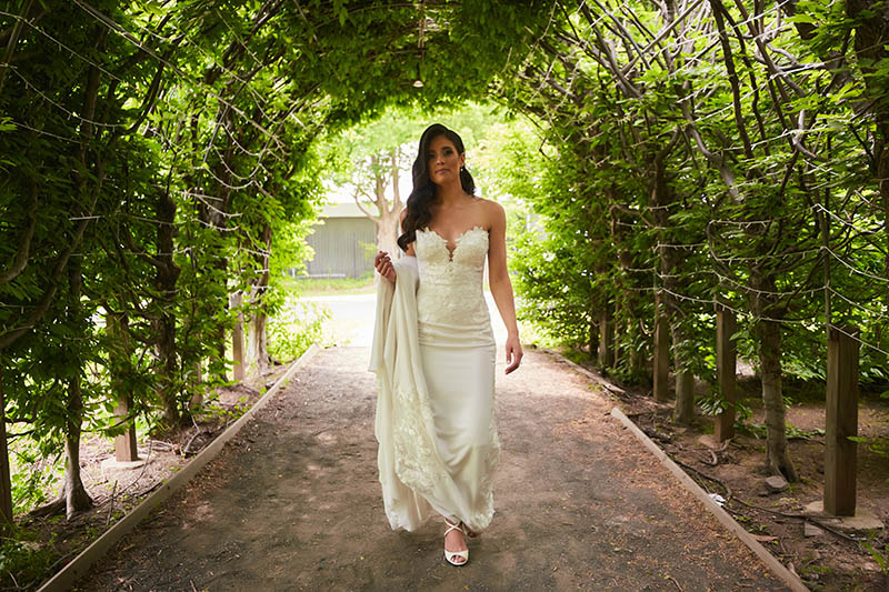 Bride walking and holding wedding dress
