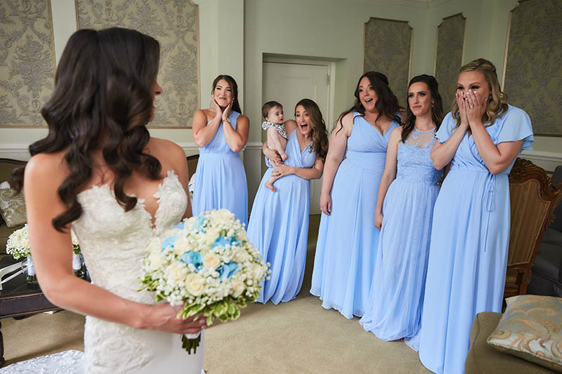 Bridesmaids react to seeing bride fully dressed