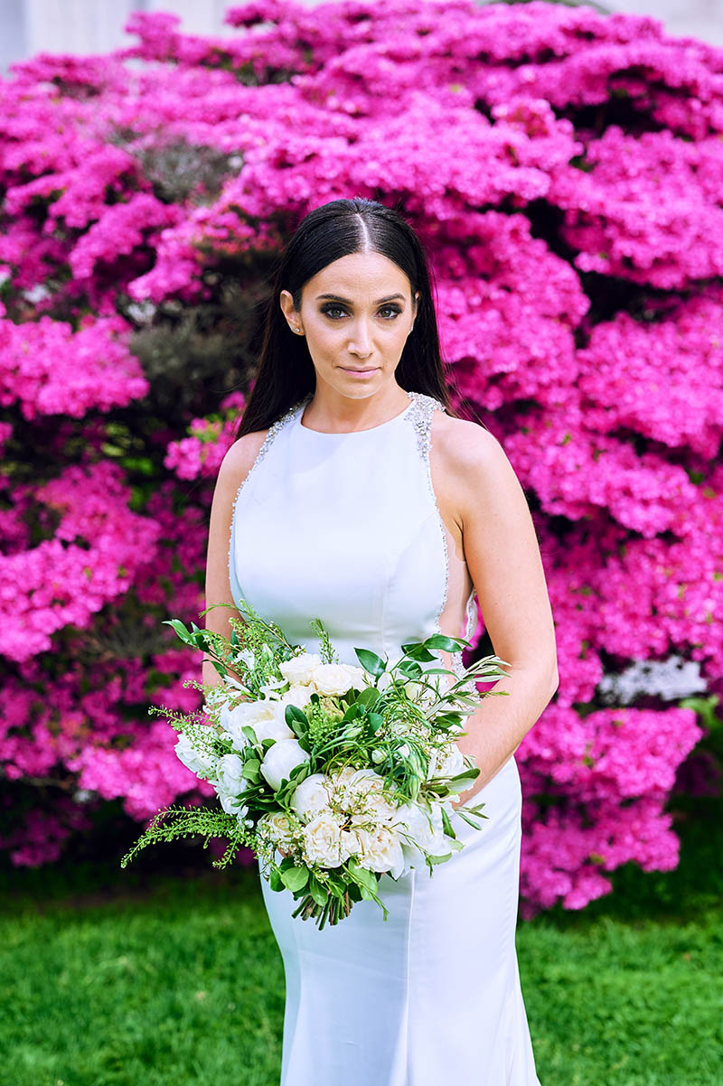 Bride portrait in front of pink flowers