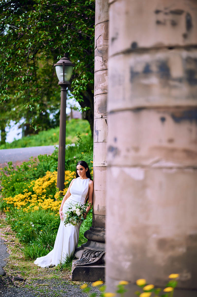 Bride leaning against the wall