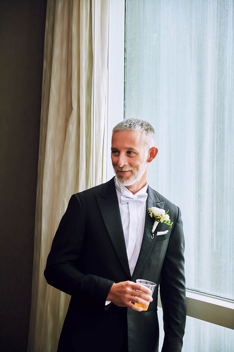 Groom portrait in front of the hotel mirror