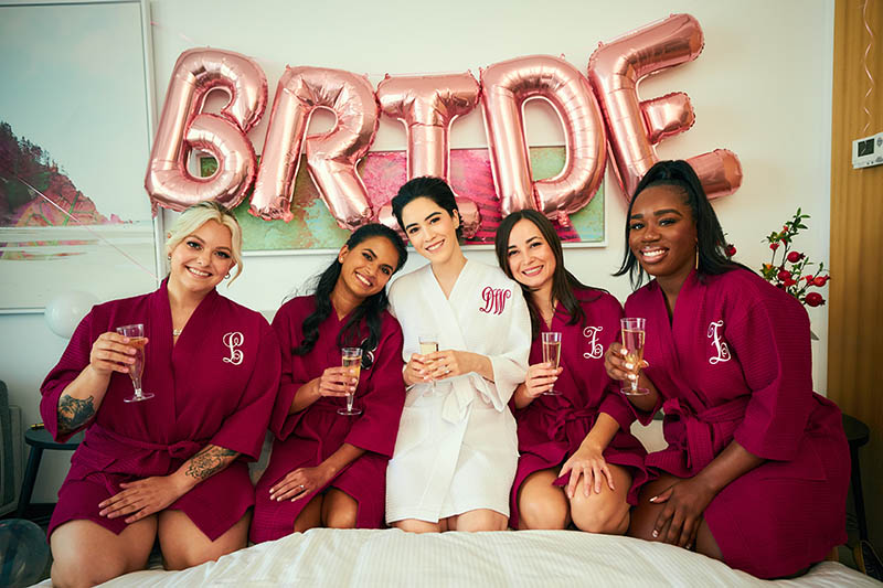 Bridesmaids in front of balloon bride sign