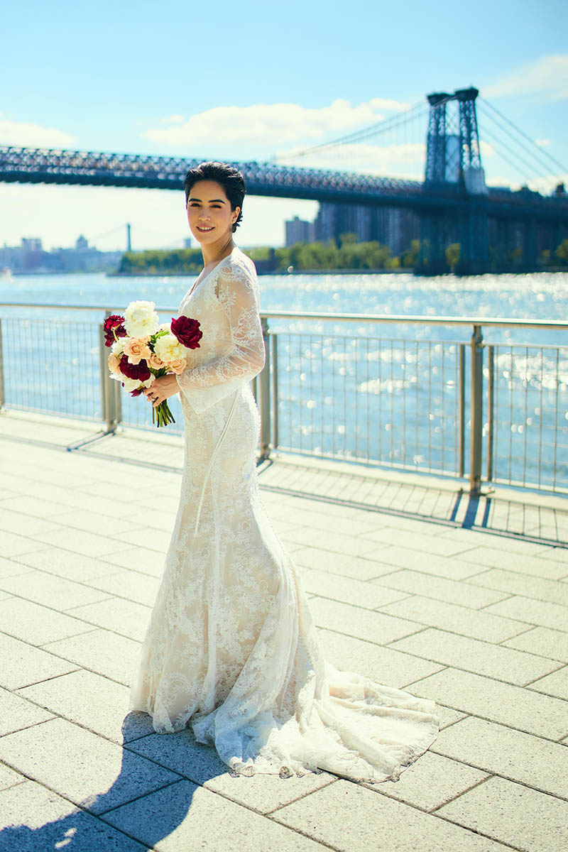 Portrait of bride holding bouquet on the waterfront