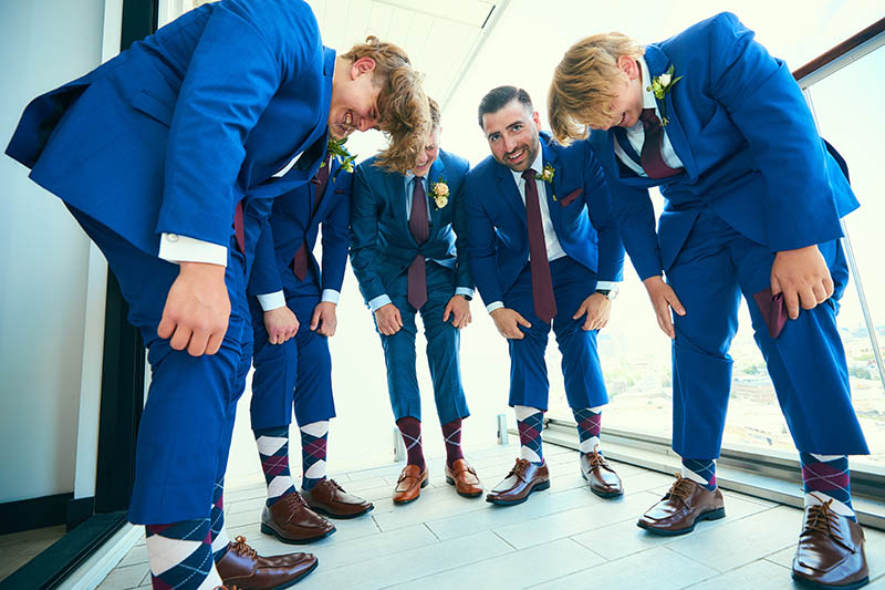 Groomsmen showing wedding socks