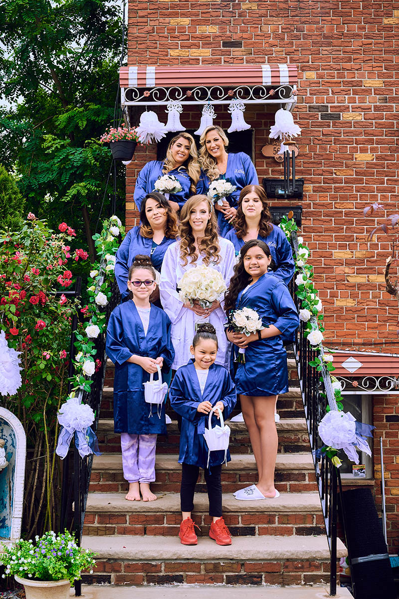 Bride with bridesmaids on door steps
