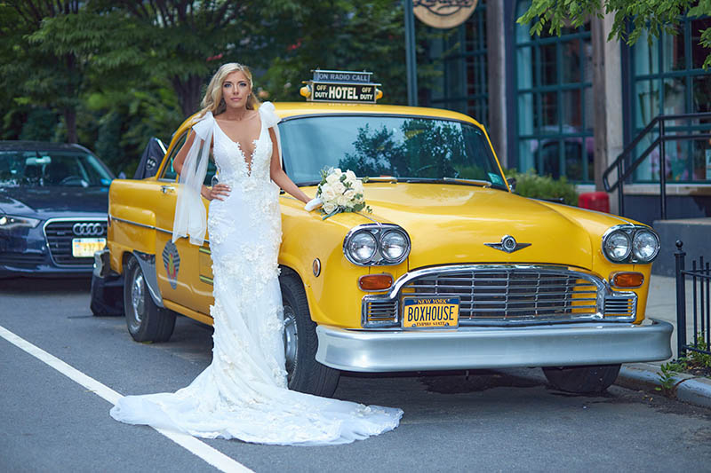 Bride in front of checkers taxi