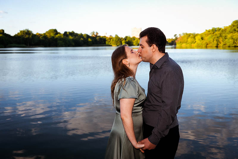 Couple kissing in front of lake