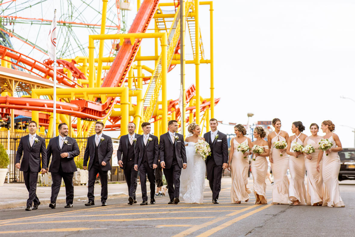 Bridal party walking on boardwalk in Coney Island