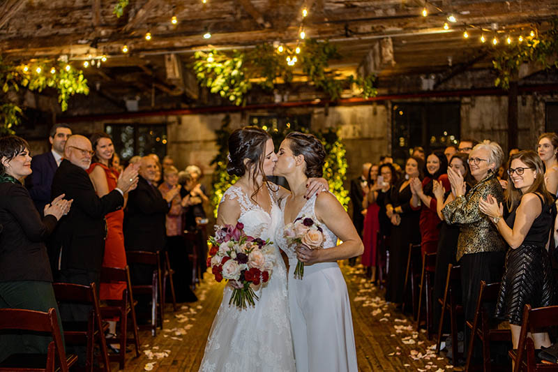 Lesbian couple kissing after wedding ceremony