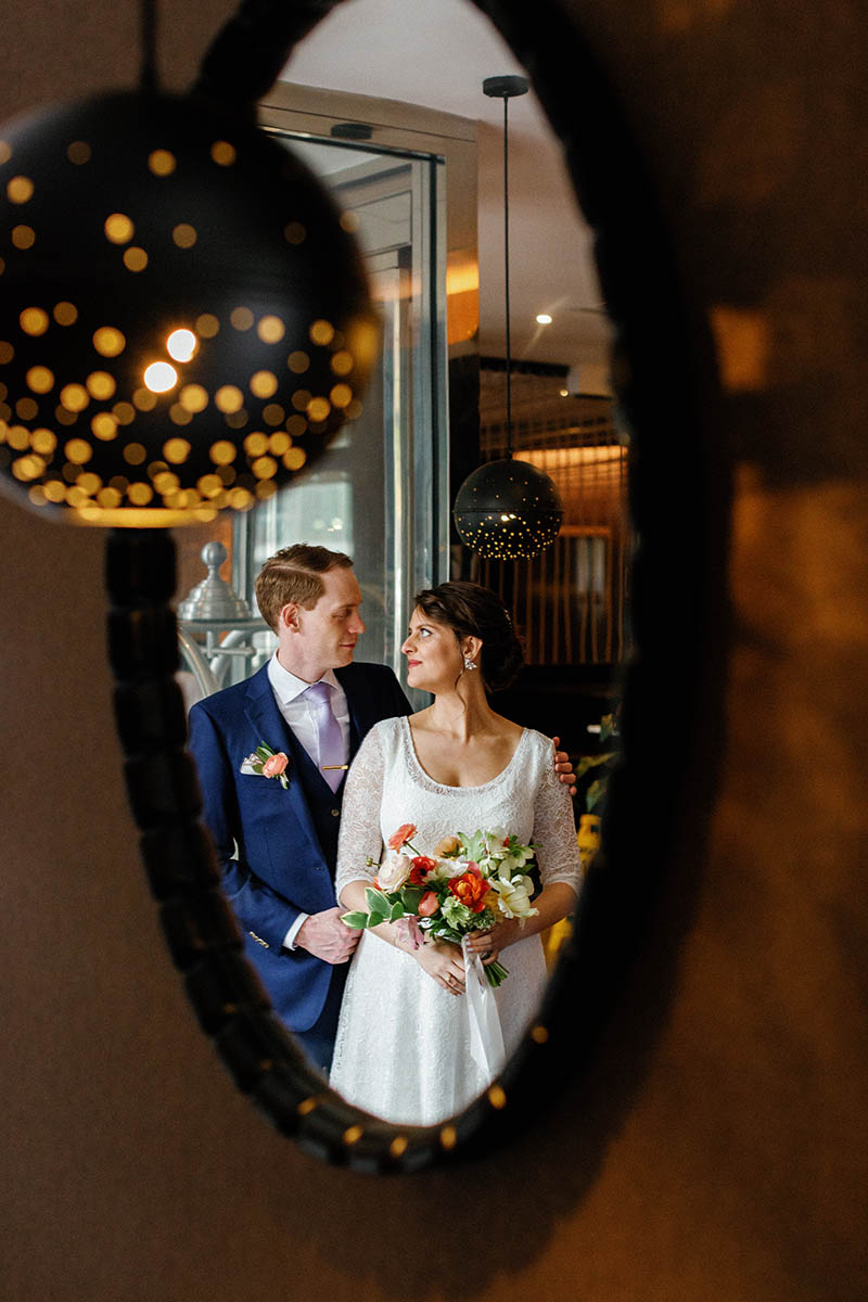 Bride and groom portrait in mirror reflection