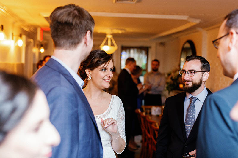 Bride chatting with guests during cocktail hour