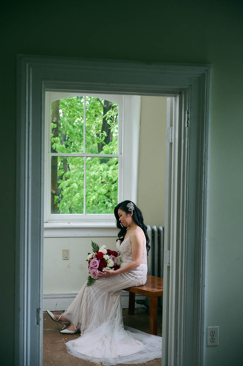 Bride sitting in chair in wedding dress