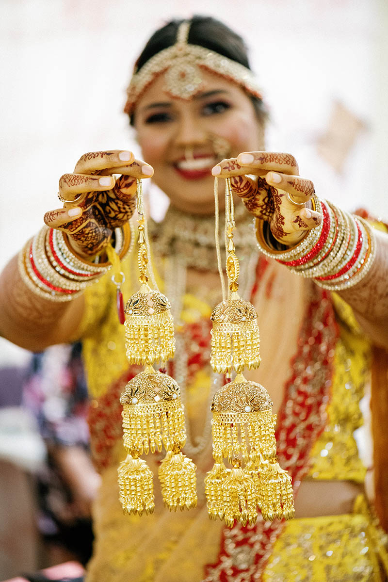 Indian bride holding jewelry