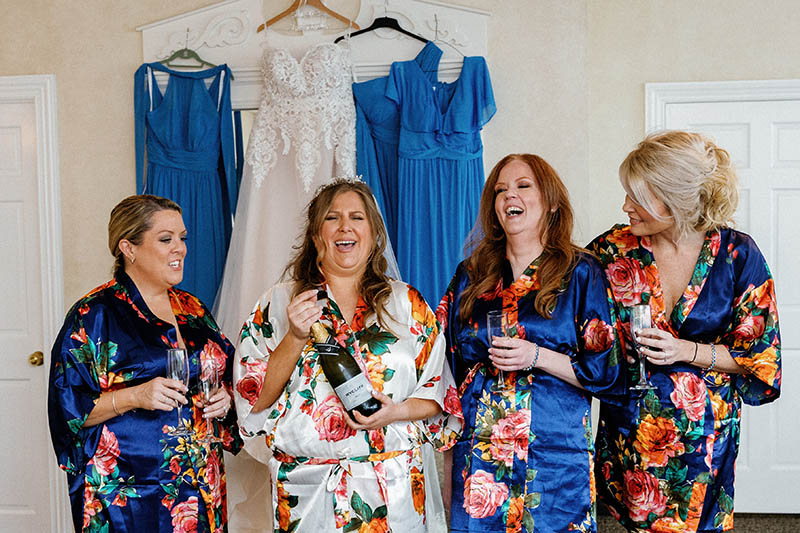 Bride with bridesmaids laughing