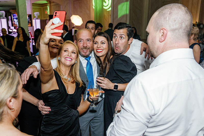 Guests taking a selfie at wedding reception