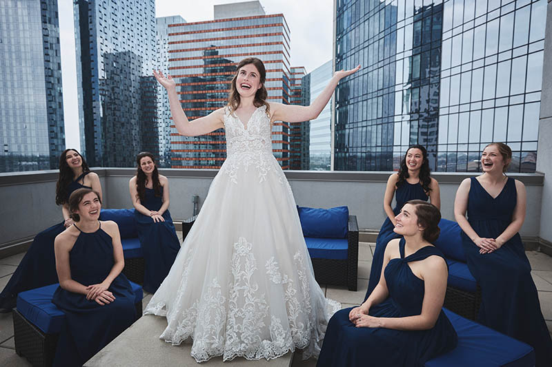 Bride raising her arms and laughing