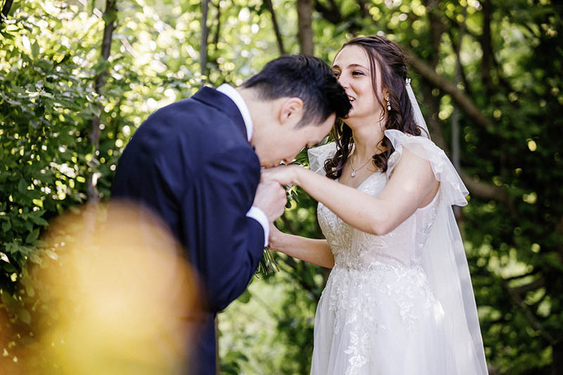 Groom kissing brides hand after reveal