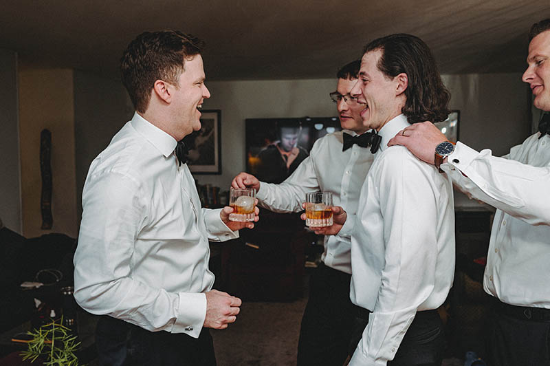 Groomsmen drinking while getting ready