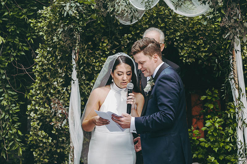 Bride and groom reading during wedding ceremony