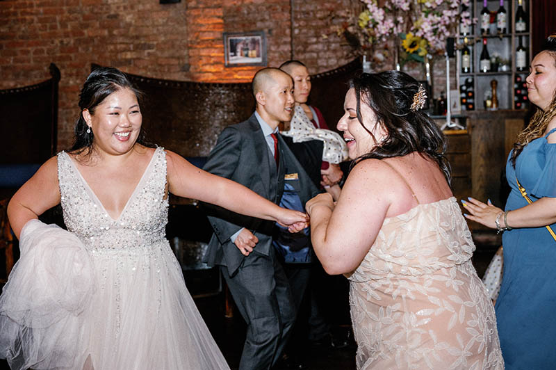 Bride dancing with friend