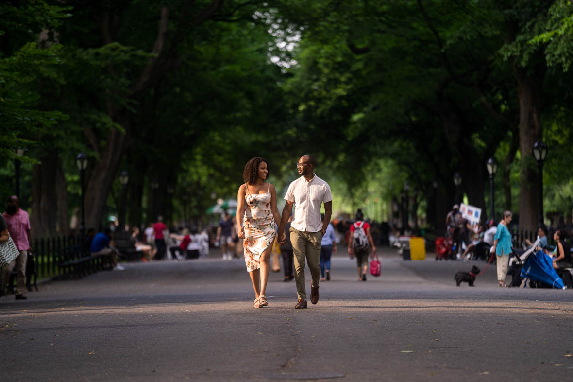 Black couple holding hands and walking in Central Park