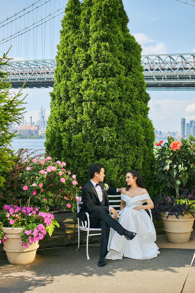 Bride and groom sitting on bench