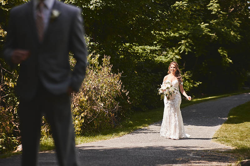 Bride walking towards groom for first look