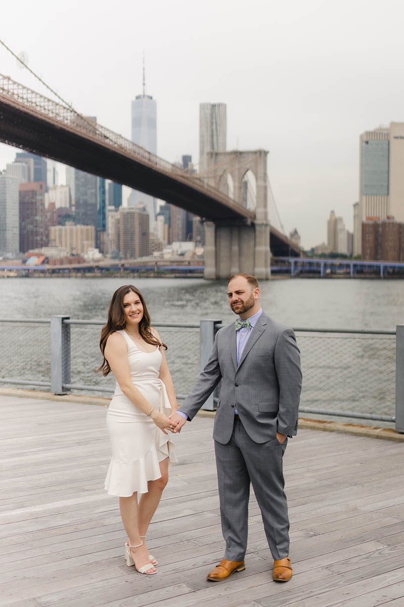 Couple holding hands in DUMBO