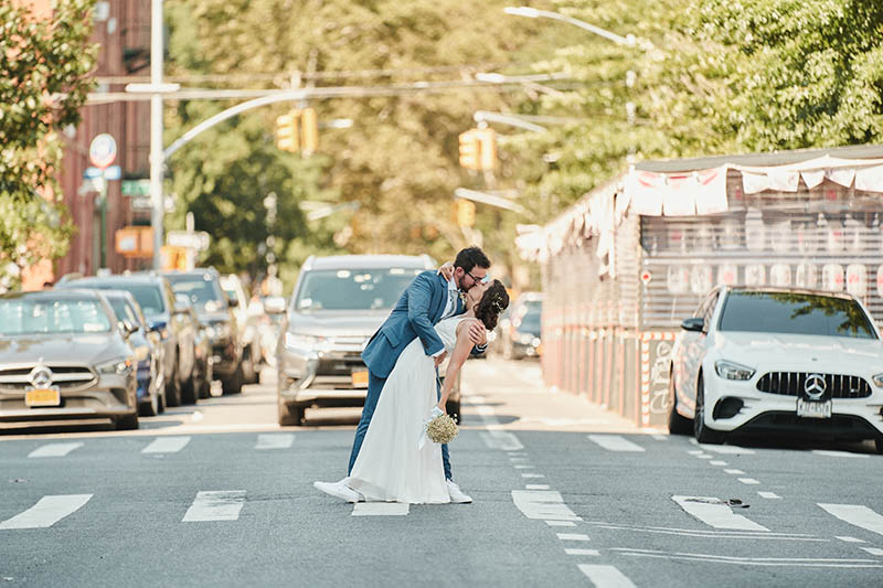Groom dipping bride in the middle of the street